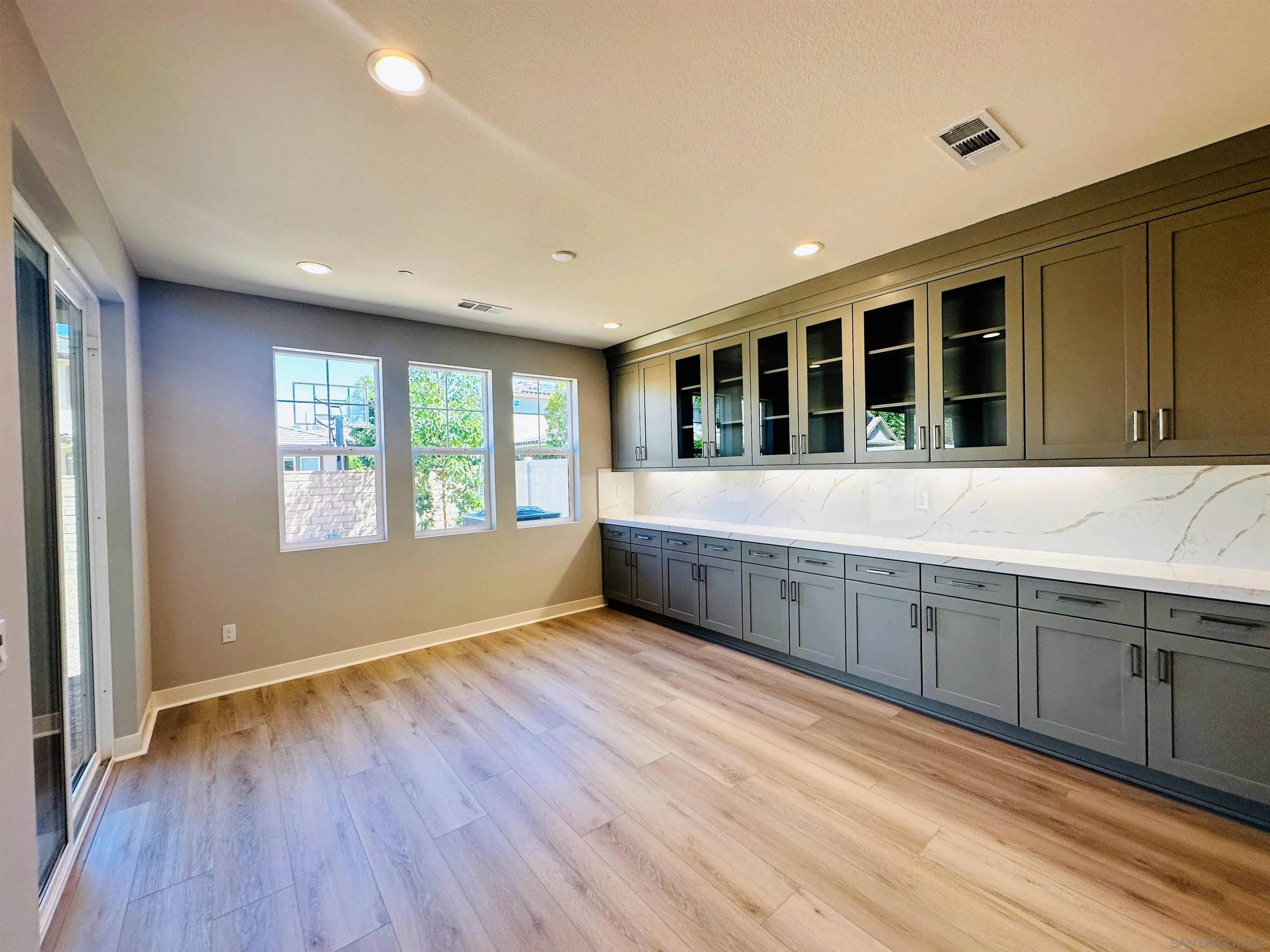 13765 Holly Oak Way Poway, CA 92064 - Photo 3 of 18 a view of an empty room with wooden floor and a window