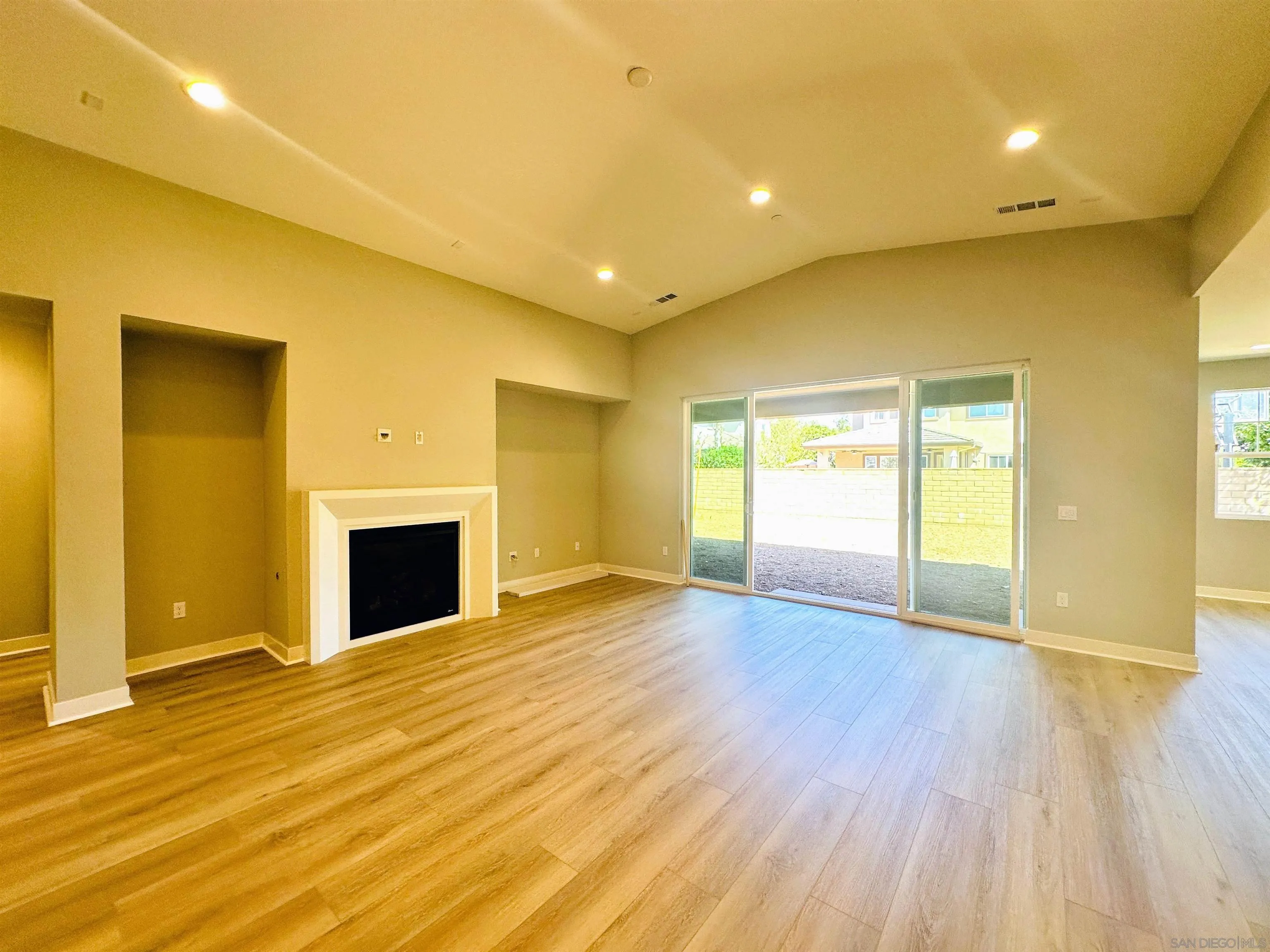 13765 Holly Oak Way Poway, CA 92064 - Photo 6 of 18 a view of empty room with wooden floor and fireplace