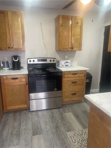 a kitchen with granite countertop a stove and a sink
