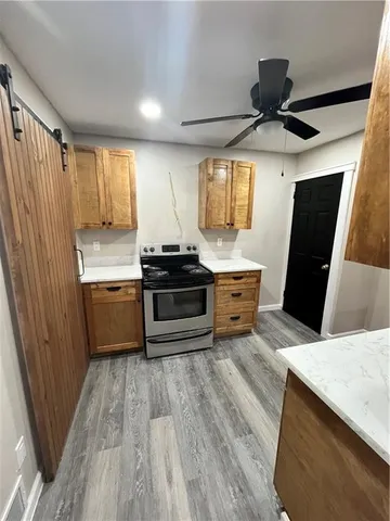 a kitchen with stainless steel appliances a stove a sink and a refrigerator