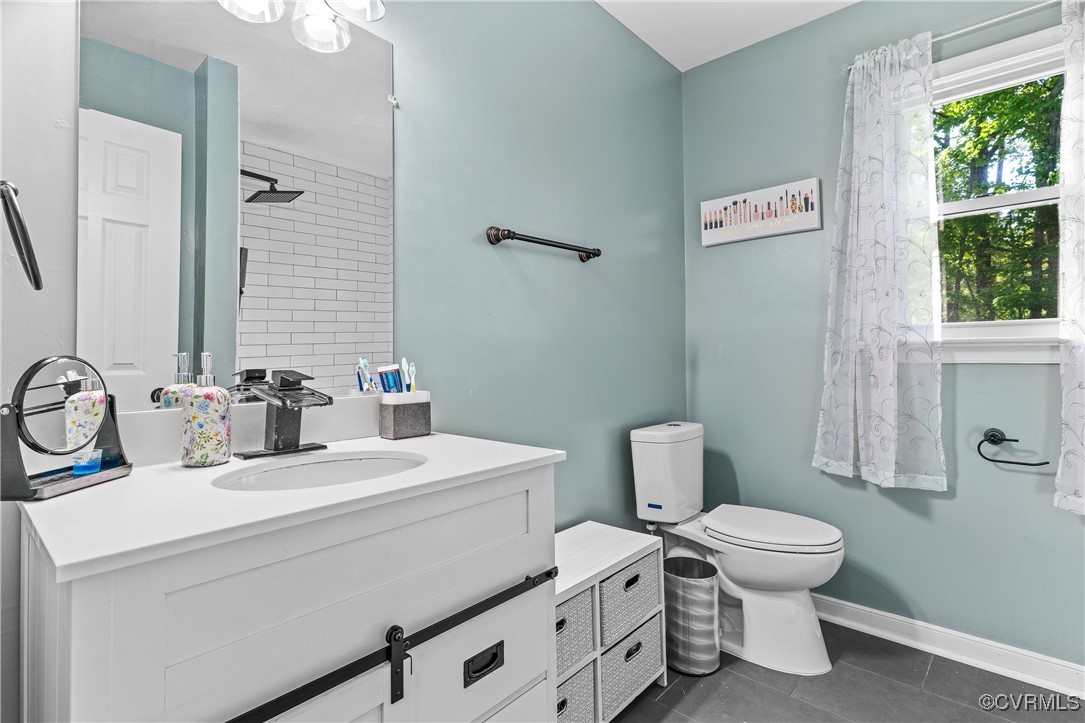 7018 Pointer Ridge Road Midlothian, VA 23112 - Photo 17 of 27 a bathroom with a toilet sink and mirror