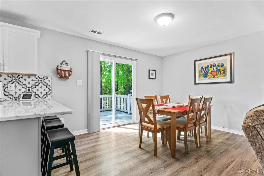 7018 Pointer Ridge Road Midlothian, VA 23112 - Photo 8 of 27 a view of a dining room with furniture and wooden floor