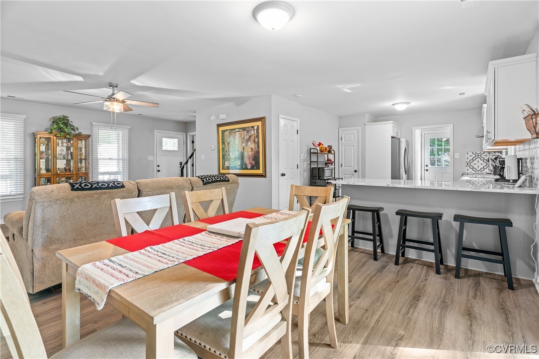 7018 Pointer Ridge Road Midlothian, VA 23112 - Photo 9 of 27 a view of a dining room with furniture and wooden floor