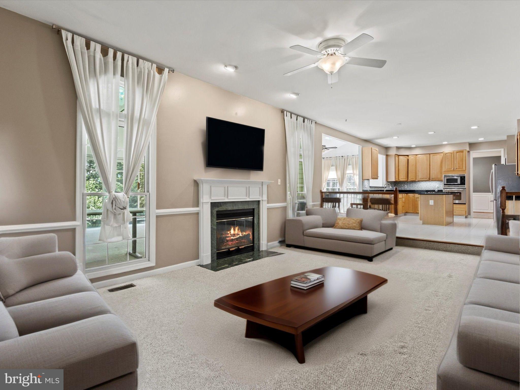 1505 Ridge Forest Way Hanover, MD 21076 - Photo 12 of 40 a living room with furniture fireplace and a flat screen tv