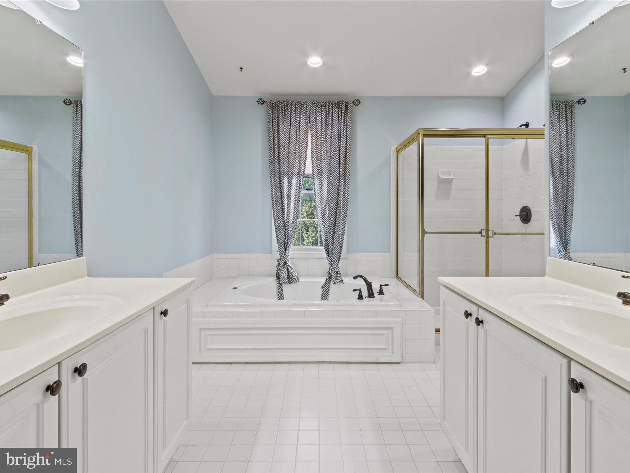 1505 Ridge Forest Way Hanover, MD 21076 - Photo 18 of 40 a spacious bathroom with a sink vanity and mirror