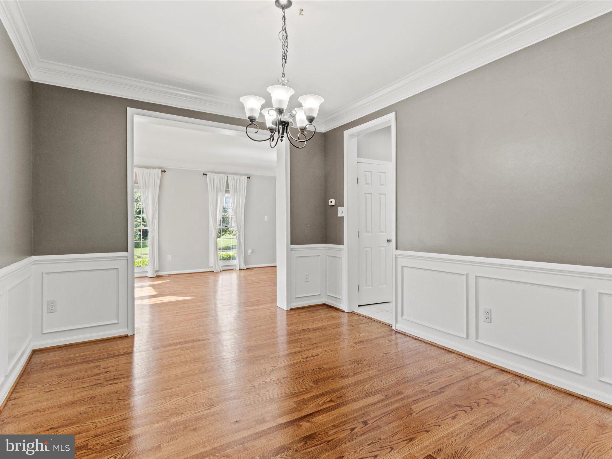 1505 Ridge Forest Way Hanover, MD 21076 - Photo 6 of 40 a view of an empty room with window and wooden floor