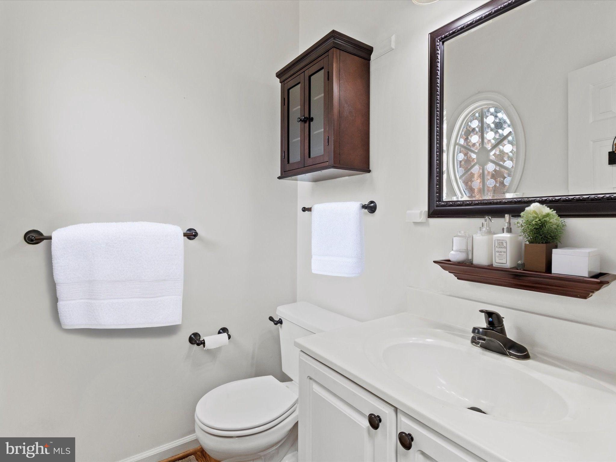 1505 Ridge Forest Way Hanover, MD 21076 - Photo 7 of 40 a bathroom with a toilet sink and mirror