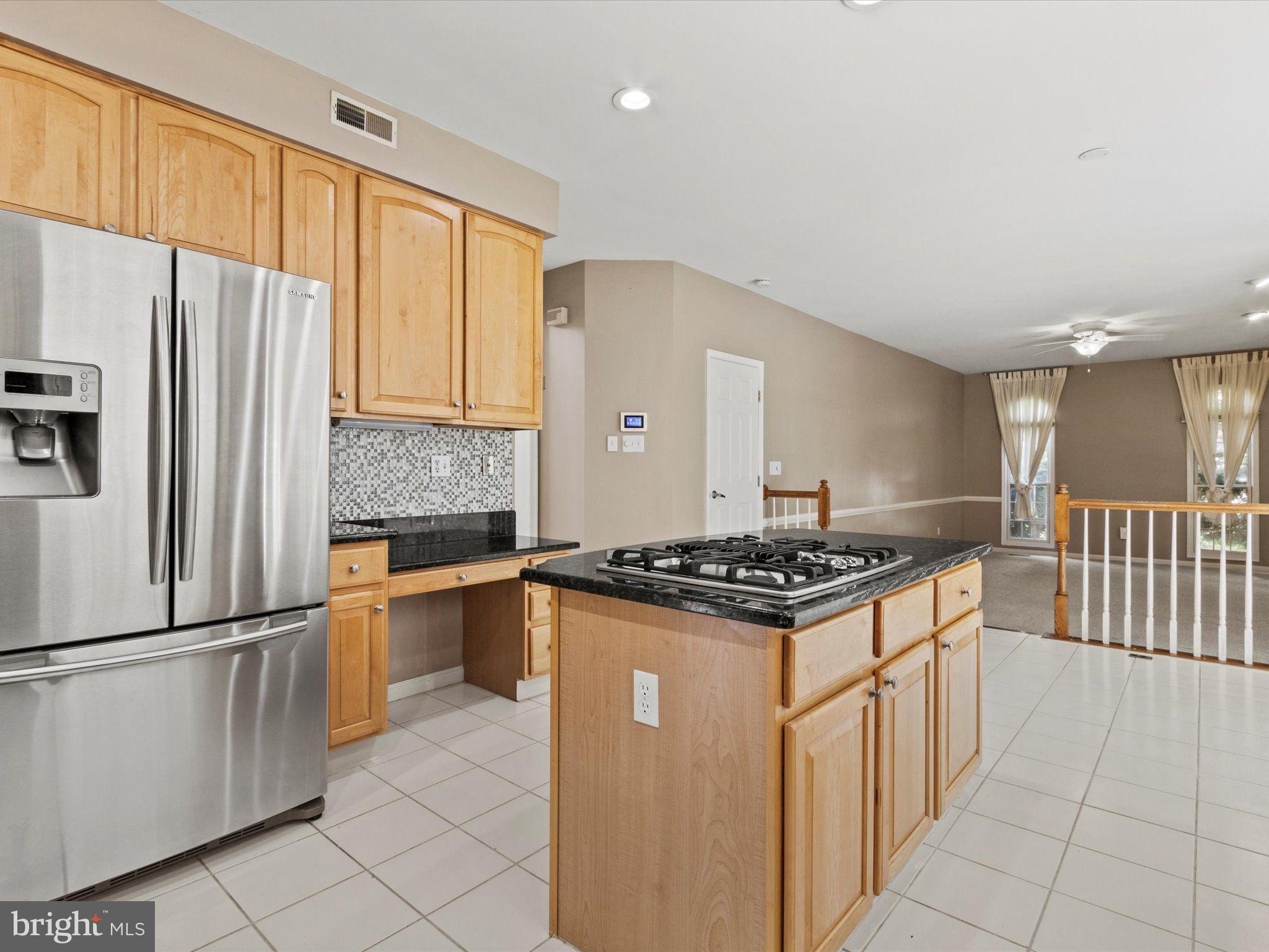 1505 Ridge Forest Way Hanover, MD 21076 - Photo 8 of 40 a kitchen with granite countertop a stove top oven and refrigerator