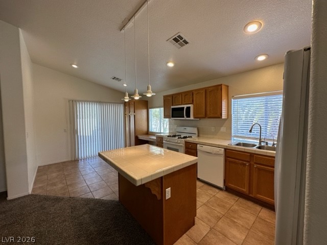285 Spring Palms Street Henderson, NV 89012 - Photo 5 of 38 Kitchen featuring visible vents, white appliances, tile counters, plenty of natural light, and a sink