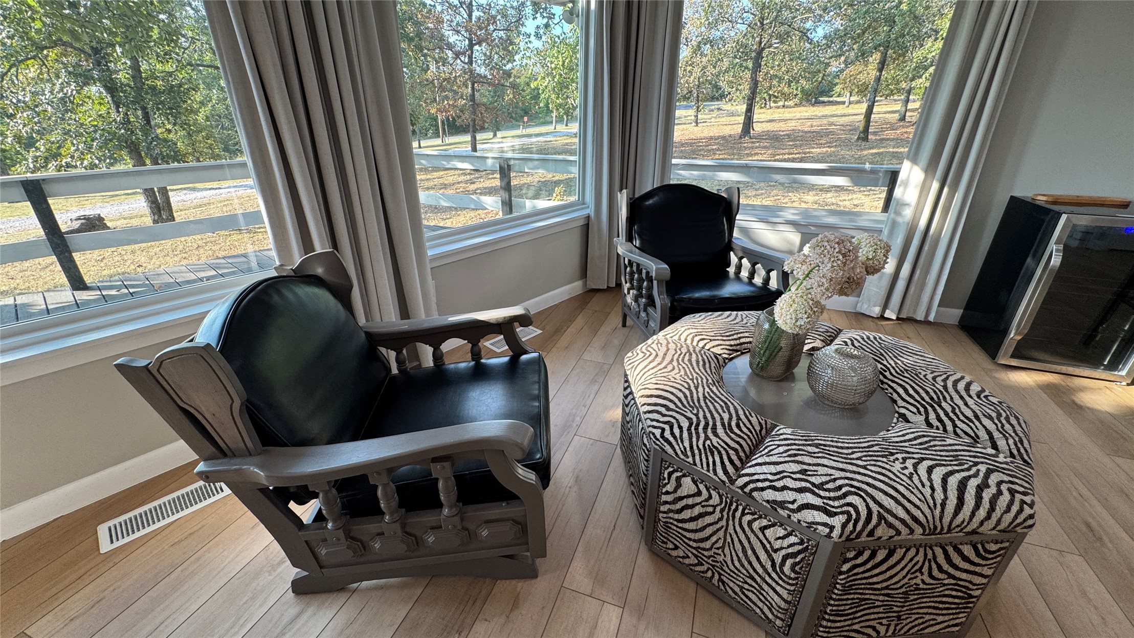 96358 South 4531 Road Vian, OK 74962 - Photo 16 of 58 Wood-finish flooring with expansive windows, neutral window treatments, and white trim