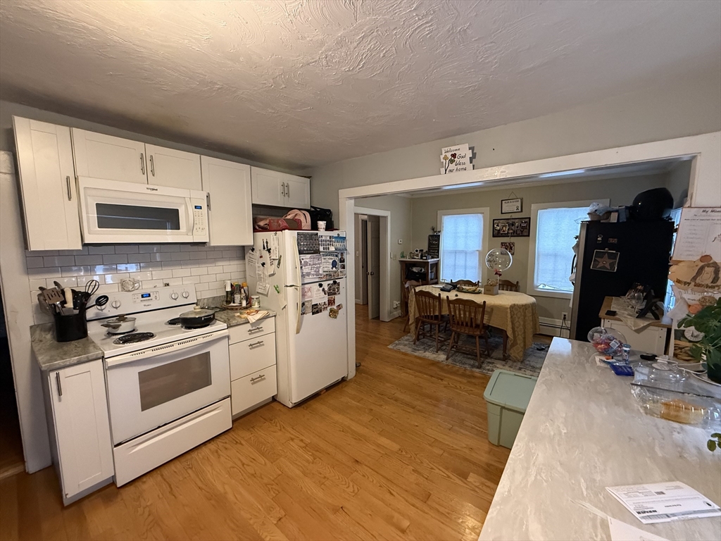 a kitchen with a sink cabinets and wooden floor