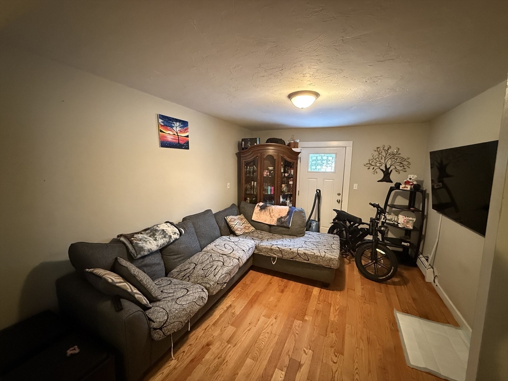 110 River Street Hudson, MA 01749 - Photo 8 of 15 a living room with furniture and a flat screen tv