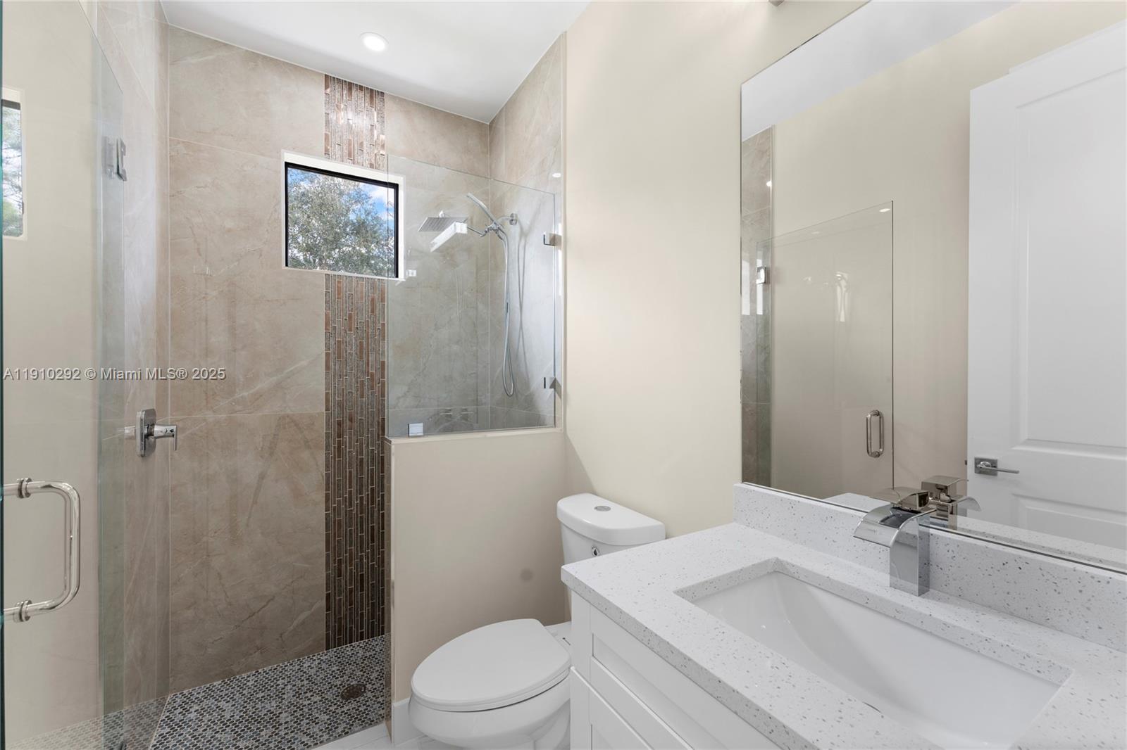 4100 8th Street Southwest Lehigh Acres, FL 33976 - Photo 13 of 24 a bathroom with a sink a toilet and shower