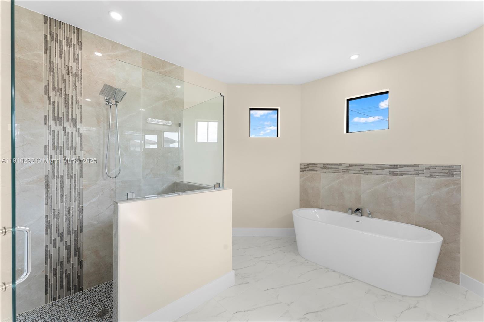 4100 8th Street Southwest Lehigh Acres, FL 33976 - Photo 18 of 24 a bathroom with a bathtub and shower