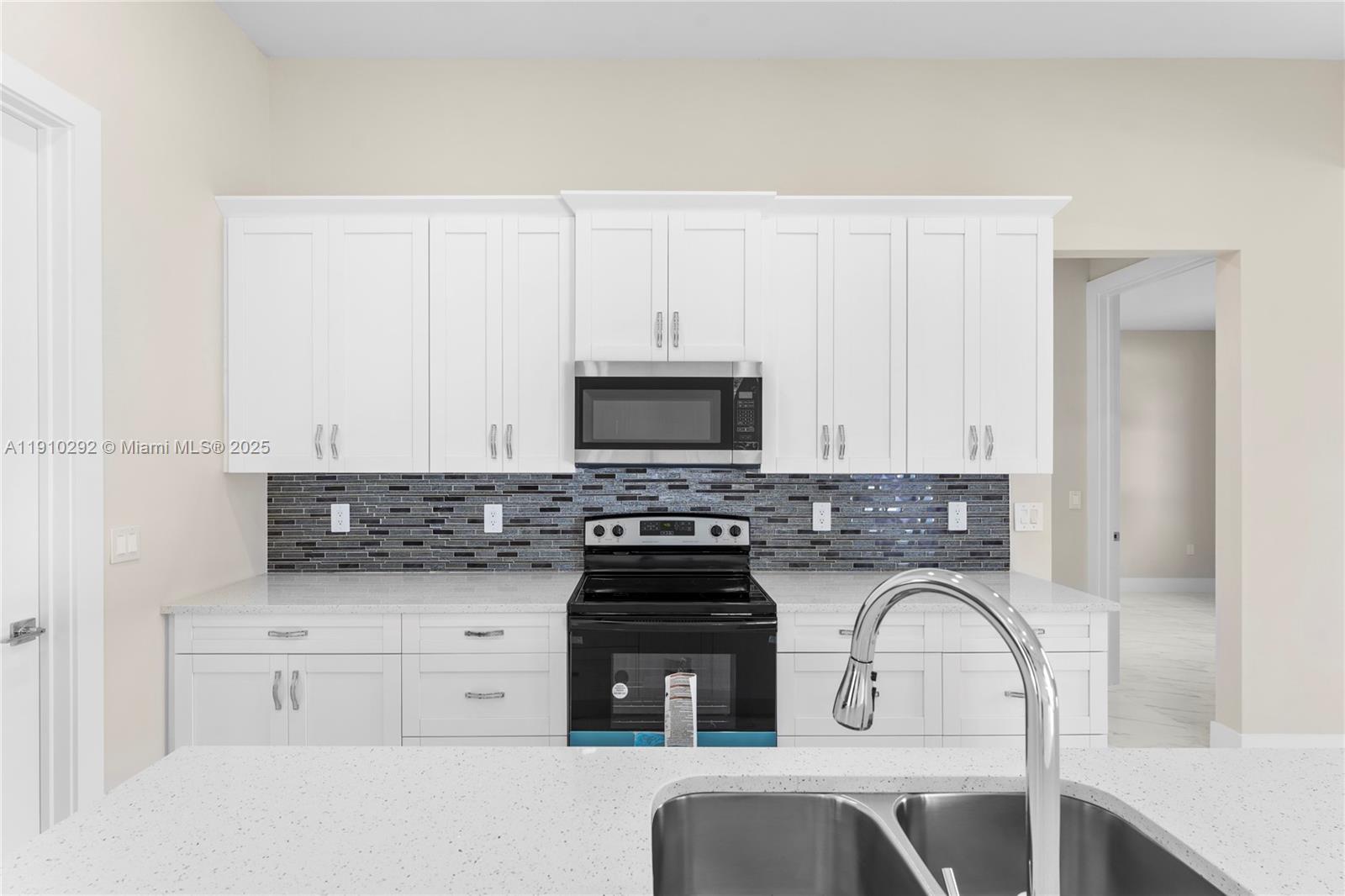 4100 8th Street Southwest Lehigh Acres, FL 33976 - Photo 9 of 24 a kitchen with granite countertop a stove a sink and a granite counter tops