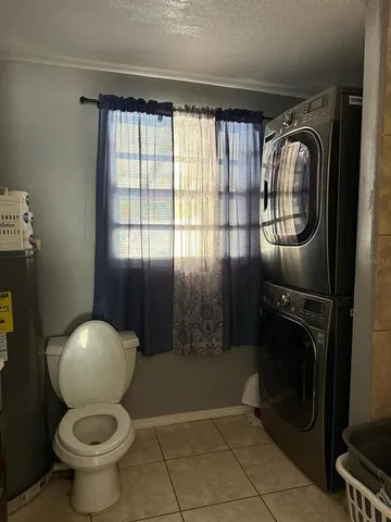 a bathroom with a toilet and a mirror