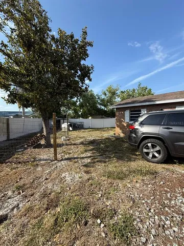 a view of a car parked in the dirt