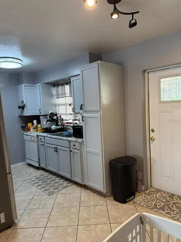 a kitchen with a refrigerator and cabinets