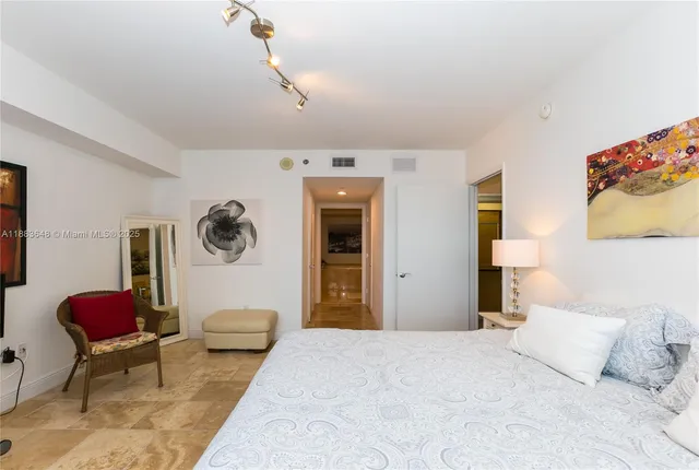 a bedroom with a bed and a couch