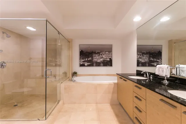 a large bathroom with a bathtub and a double vanity sink