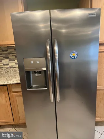 a kitchen with granite countertop a stove top oven microwave and cabinets