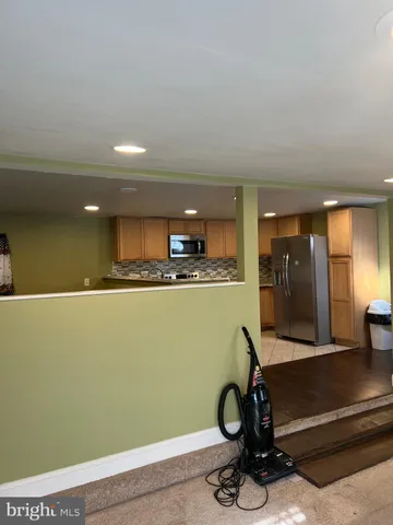 a view of a kitchen with stainless steel appliances granite countertop a sink and a stove