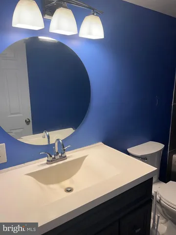 a bathroom with a toilet and shower curtain