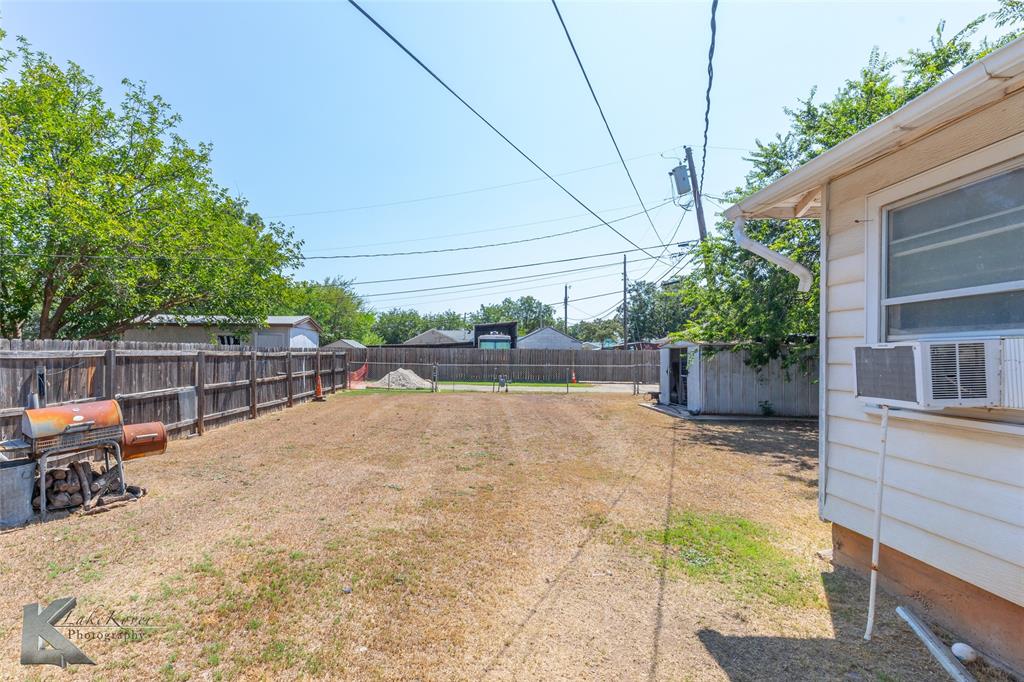 1649 South 16th Street Abilene, TX 79602 - Photo 21 of 24 a view of backyard with wheel chair potted plants and large tree