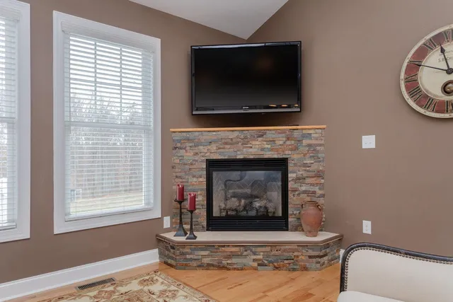 a bed room with a bed and paintings on the wall