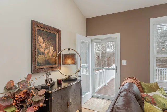 a view of a room with furniture and wooden floor