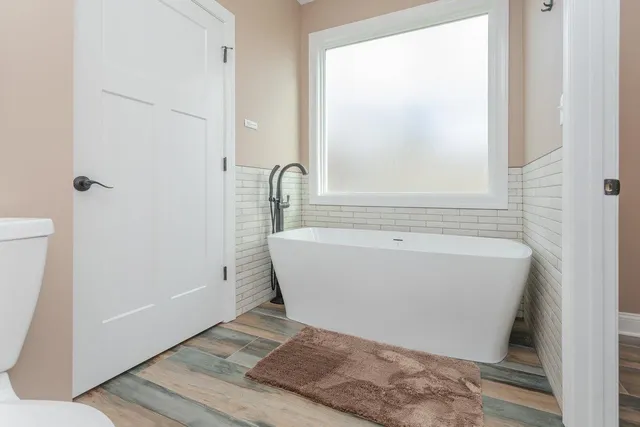 a bathroom with a toilet a sink and shower