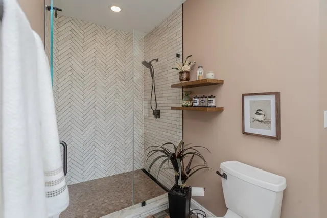 a bathroom with a shower and a mirror