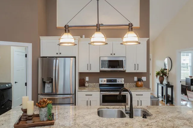 a view of a dining room with furniture a chandelier and wooden floor