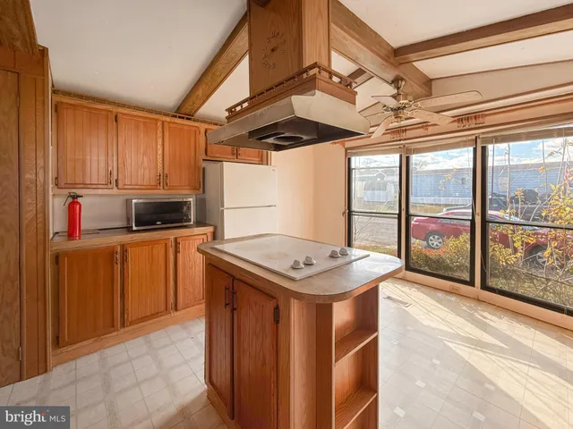 a kitchen with a stove a sink and a refrigerator