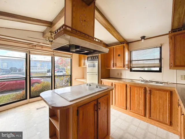 a kitchen with stainless steel appliances granite countertop a sink and cabinets