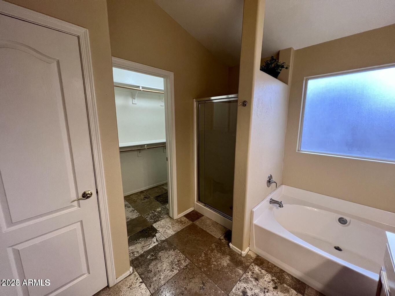 18630 North 28th Way Phoenix, AZ 85050 - Photo 12 of 18 a bathroom with a tub a toilet and a sink