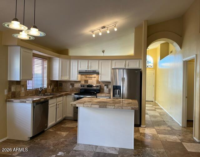 18630 North 28th Way Phoenix, AZ 85050 - Photo 17 of 18 a kitchen with kitchen island granite countertop stainless steel appliances a sink a stove top oven a counter space and cabinets