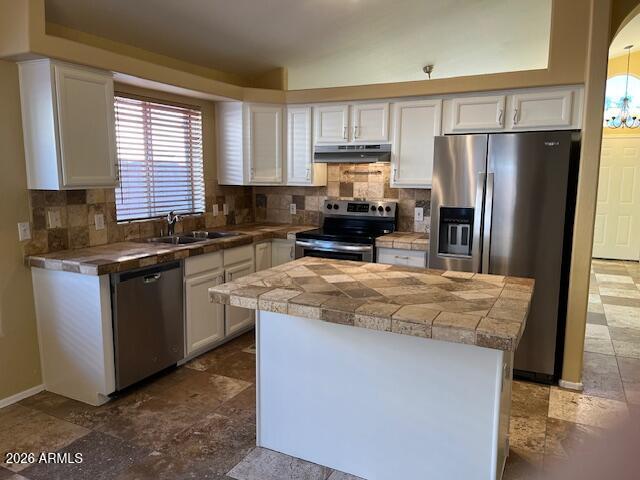 18630 North 28th Way Phoenix, AZ 85050 - Photo 4 of 18 a kitchen with kitchen island granite countertop a stove top oven a refrigerator a sink and dishwasher