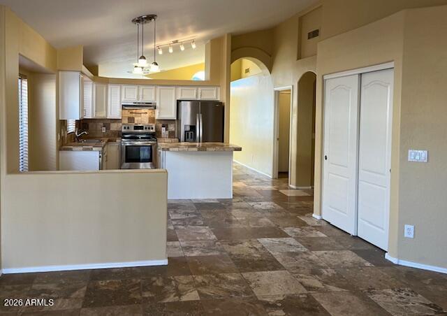 18630 North 28th Way Phoenix, AZ 85050 - Photo 5 of 18 a living room with couches a flat screen tv and kitchen view