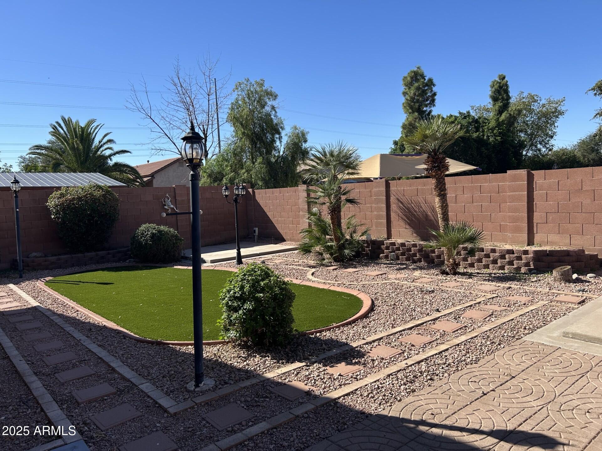 18630 North 28th Way Phoenix, AZ 85050 - Photo 7 of 18 a view of a backyard with plants and swimming pool