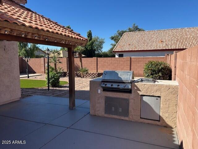18630 North 28th Way Phoenix, AZ 85050 - Photo 8 of 18 a view of a kitchen with a sink and dishwasher with a barbeque