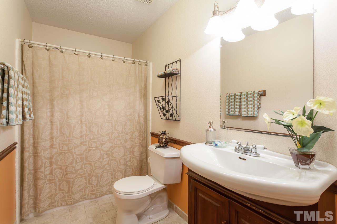8008 Chadbourne Court Raleigh, NC 27613 - Photo 14 of 25 a bathroom with a sink toilet and shower