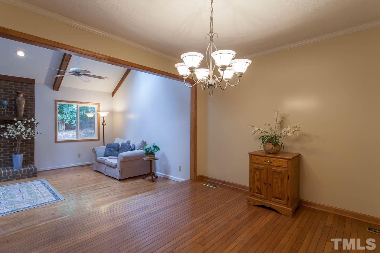 8008 Chadbourne Court Raleigh, NC 27613 - Photo 8 of 25 a view of a livingroom with a chandelier