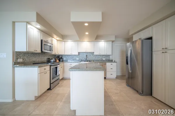 a kitchen with a refrigerator sink and cabinets