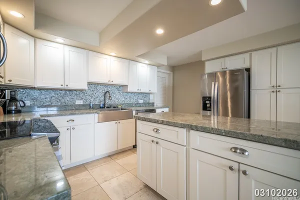 a kitchen with stainless steel appliances granite countertop a sink and cabinets