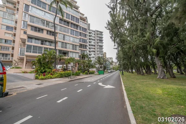 a view of a tall building with a garden
