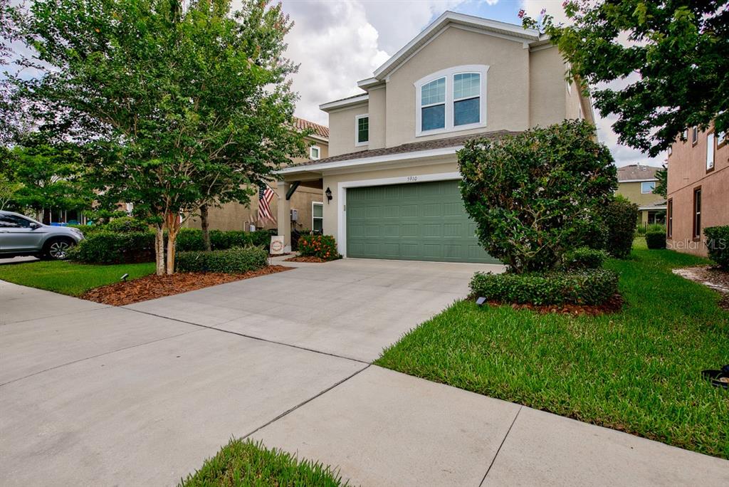 a front view of house with yard and green space