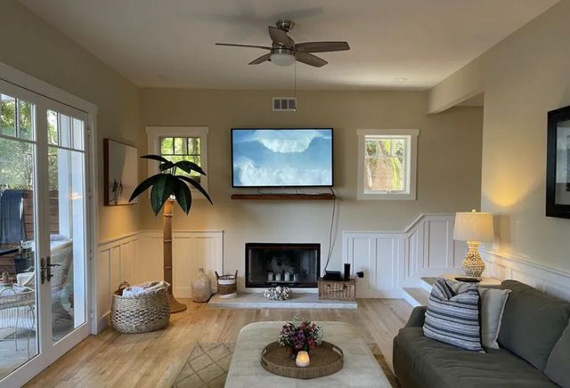 a living room with furniture a fireplace and a flat screen tv
