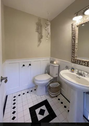 a bathroom with a sink toilet and mirror