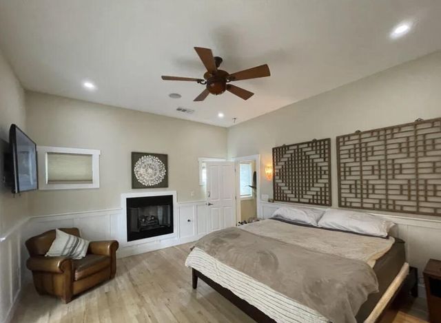 a bedroom with a bed and a fireplace